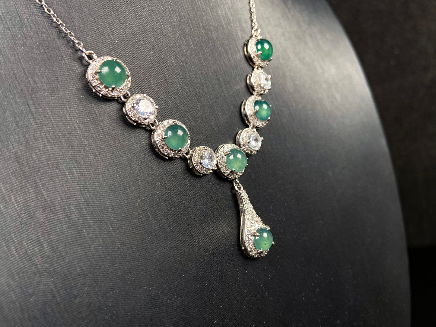 A lush green teardrop jadeite pendant.