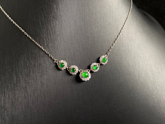 A jadeite pendant featuring five green beads exquisitely set in 925 silver.