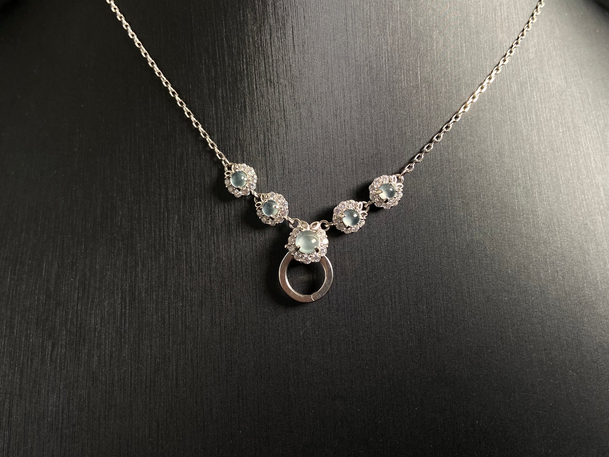A jade pendant featuring five icy toned beads, each elegantly set in 925 silver.