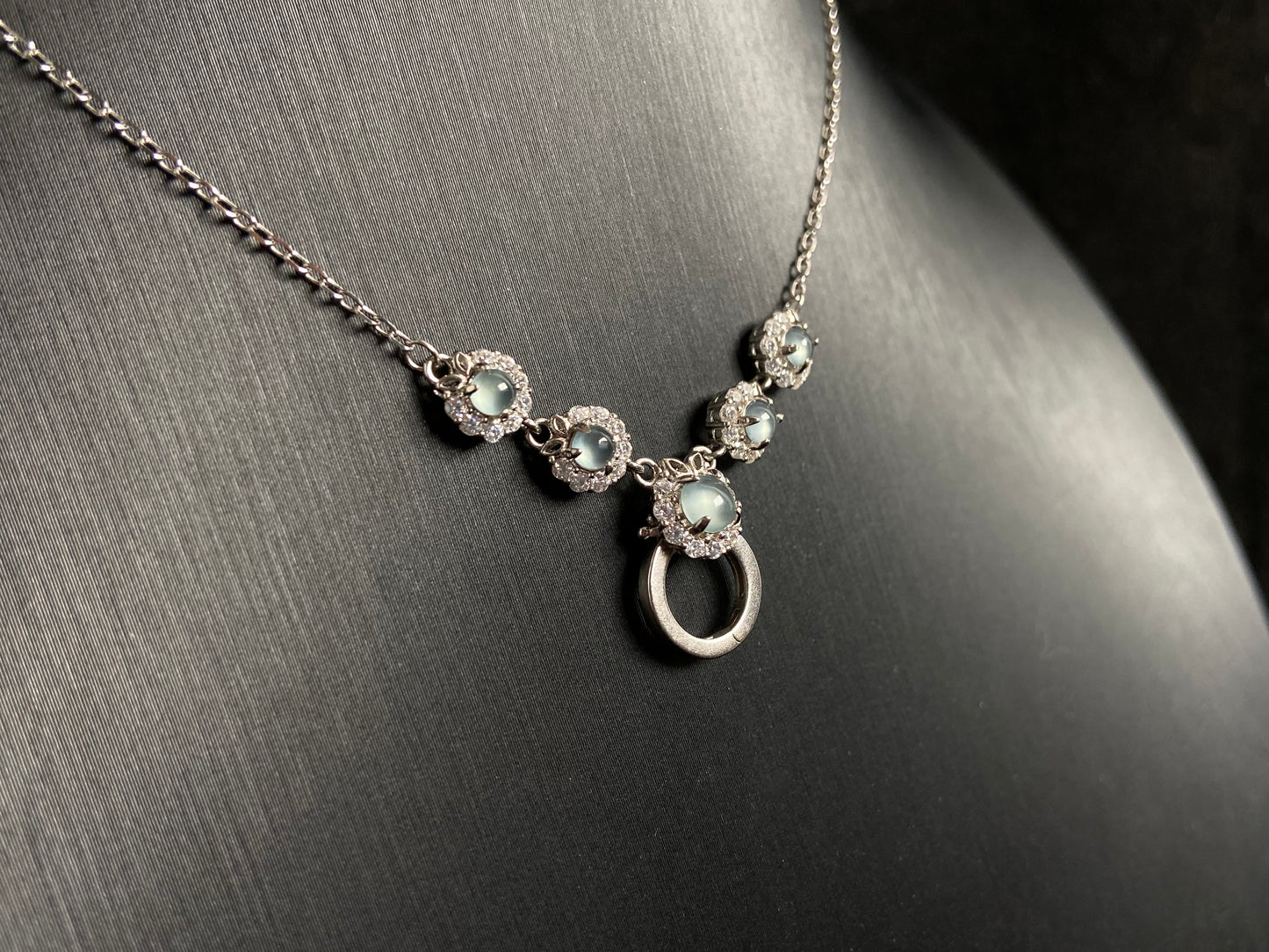 A jade pendant featuring five icy toned beads, each elegantly set in 925 silver.
