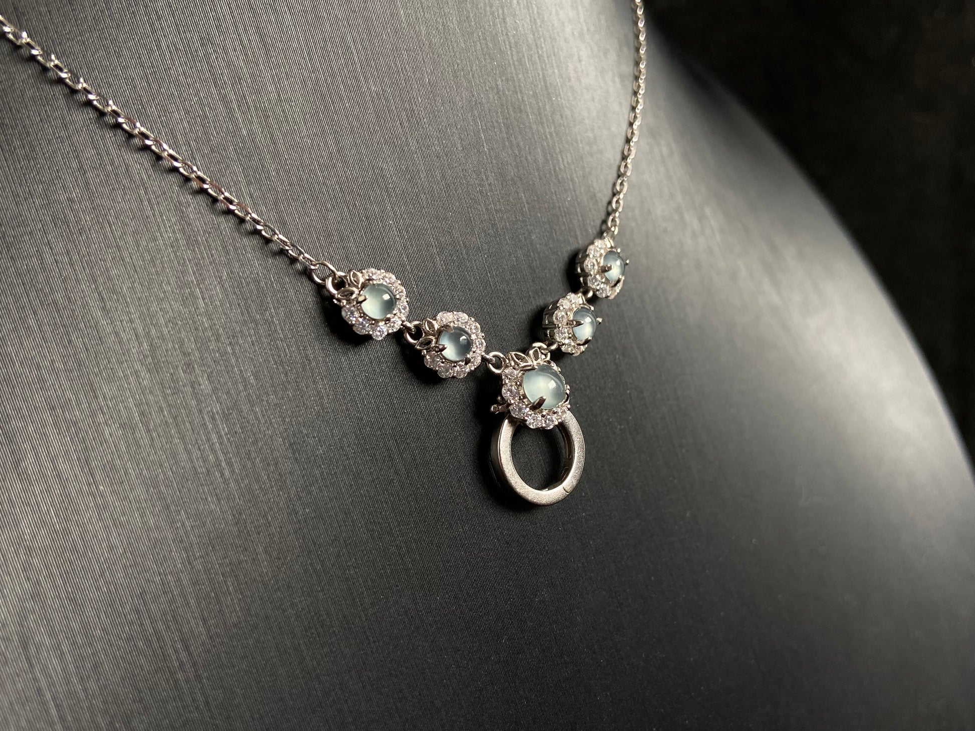 A jade pendant featuring five icy toned beads, each elegantly set in 925 silver.