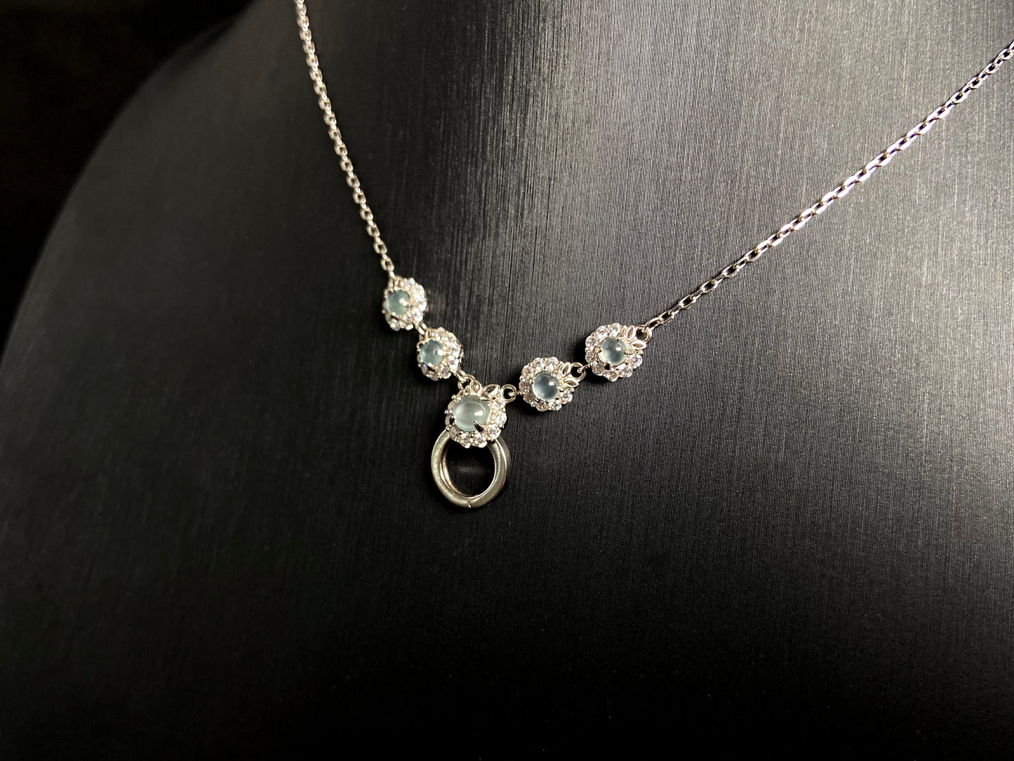 A jade pendant featuring five icy toned beads, each elegantly set in 925 silver.