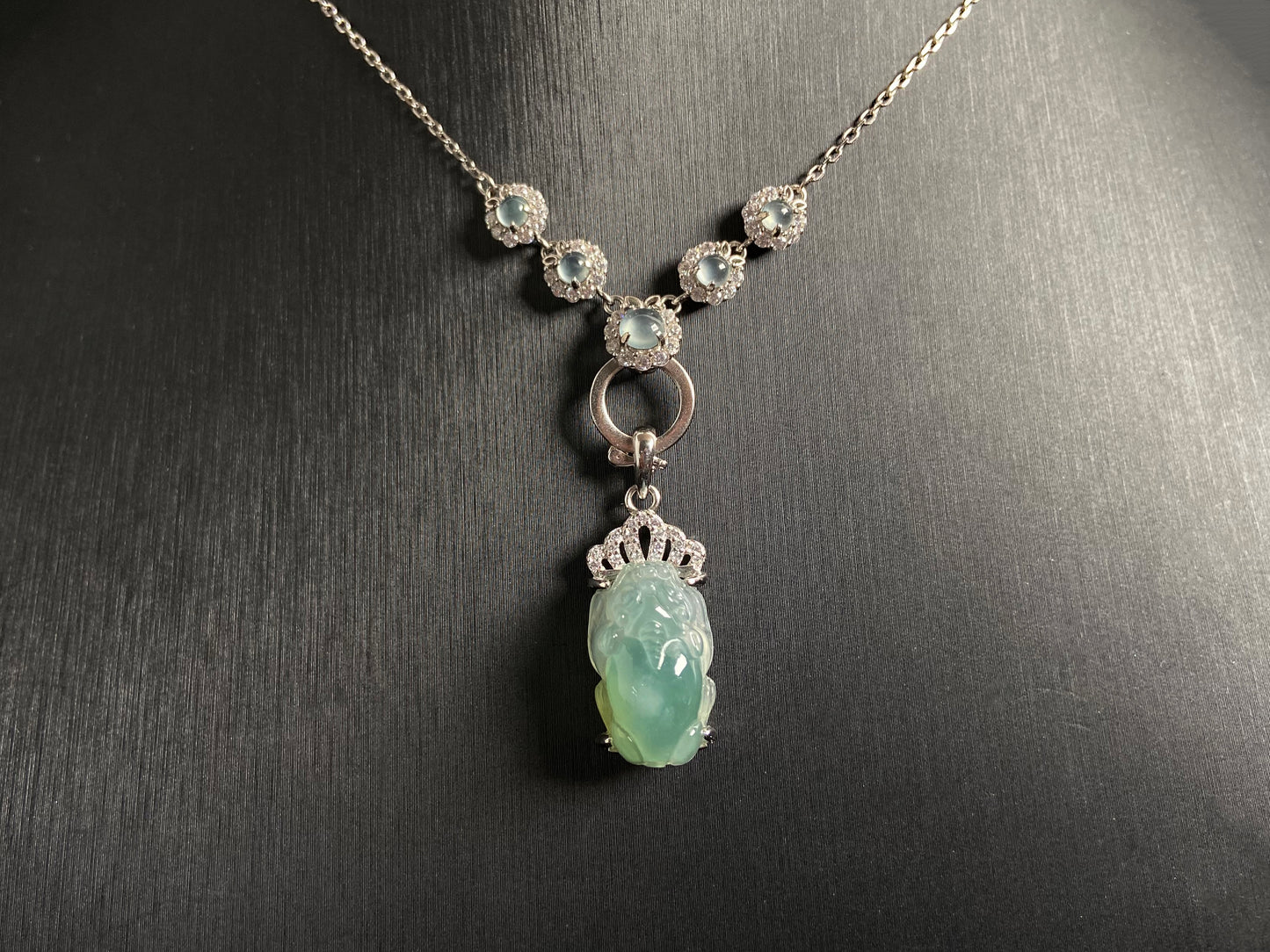 A versatile jade pendant set featuring five icy beads set in 925 silver, convertible with a detachable light green Pixiu charm crowned in sterling silver.