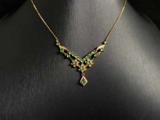 A delicate pendant featuring 19 transparent green jade beads, elegantly set in gold plated 925 silver.