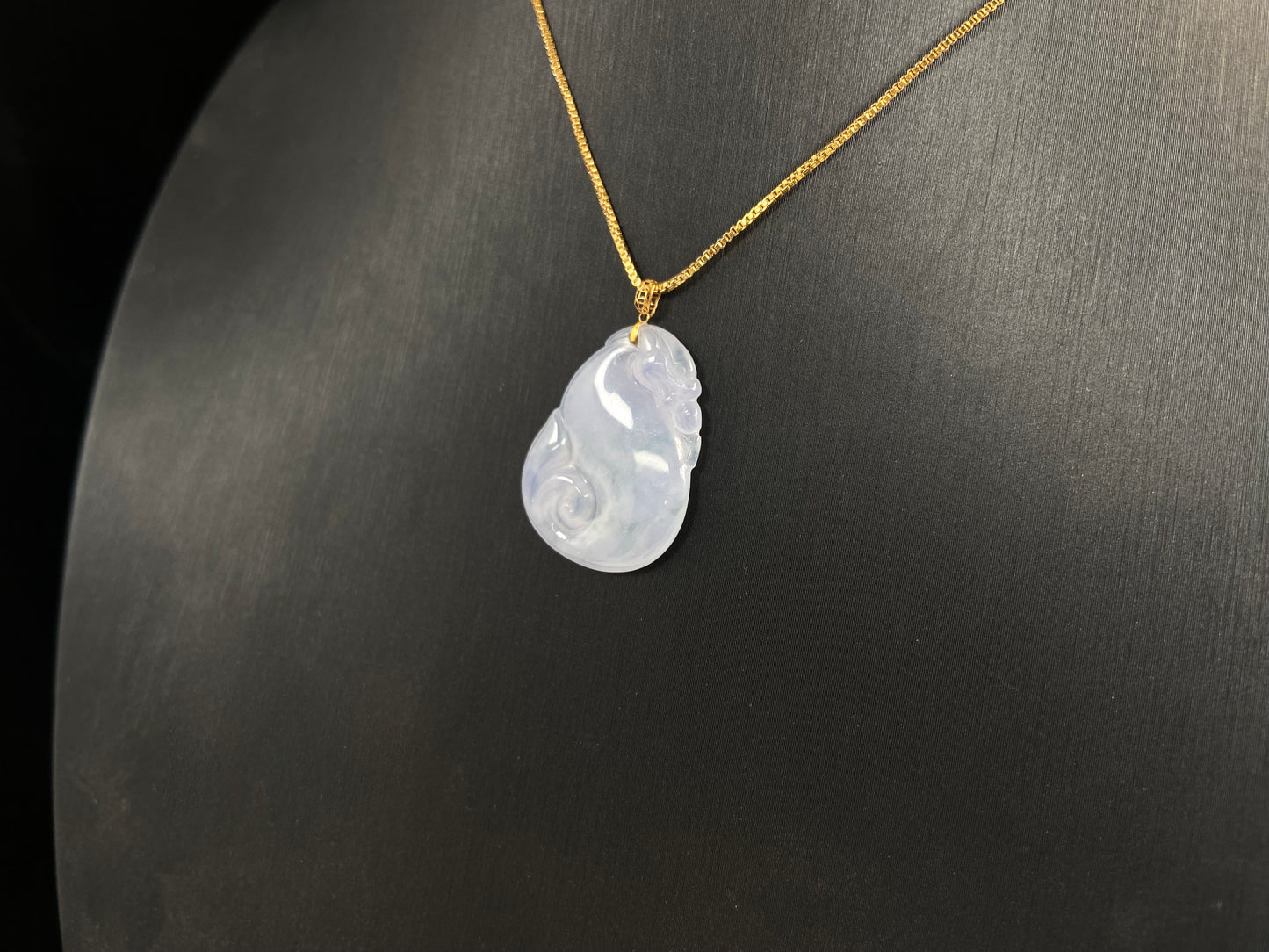 An icy jadeite carving of a Pixiu with a Ruyi body.