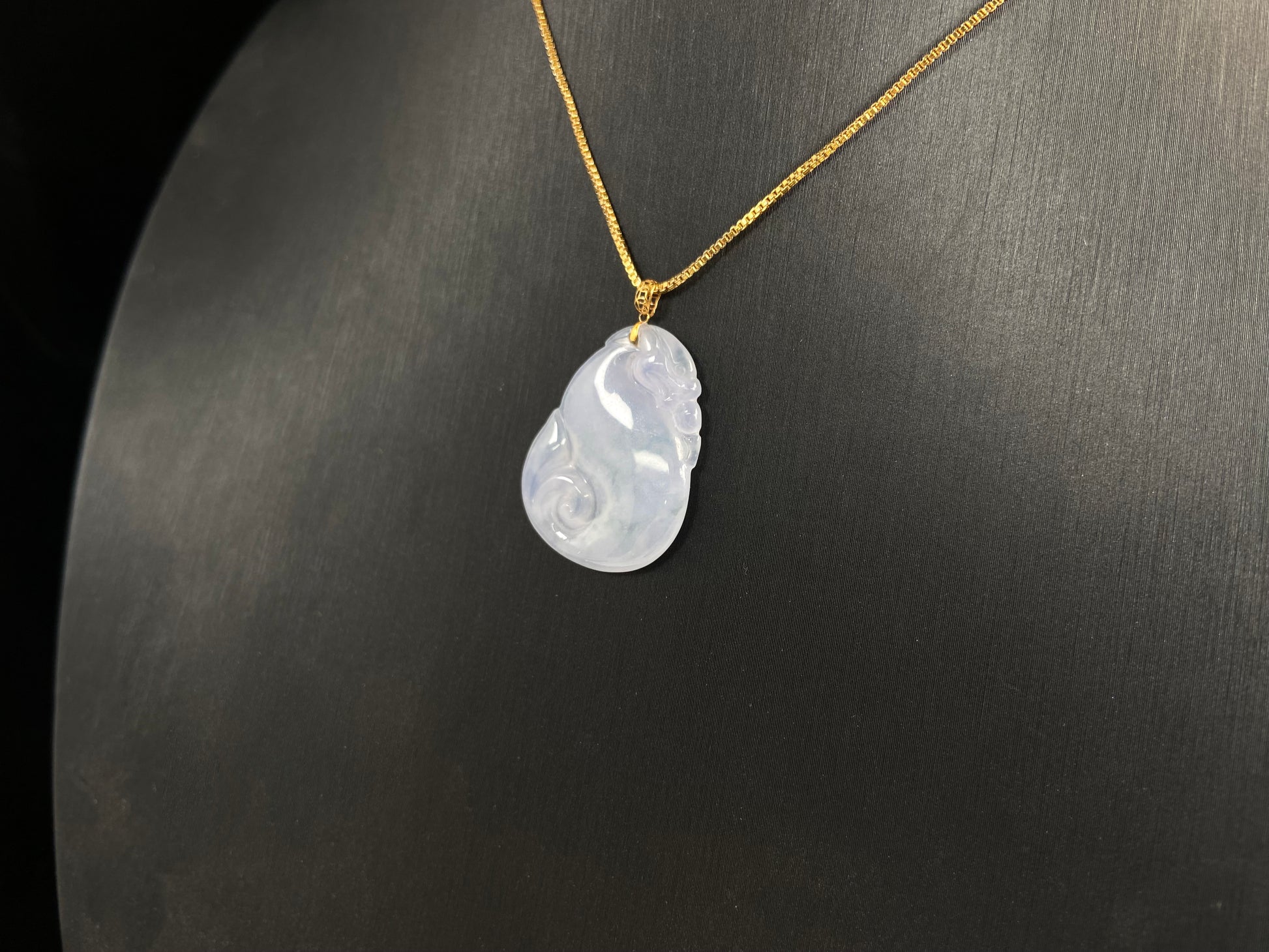 An icy jadeite carving of a Pixiu with a Ruyi body.