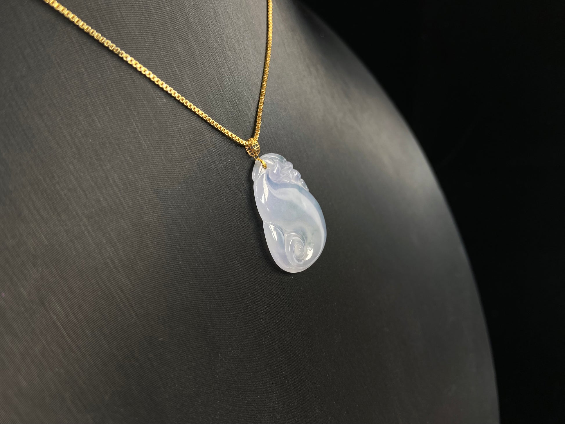 An icy jadeite carving of a Pixiu with a Ruyi body.