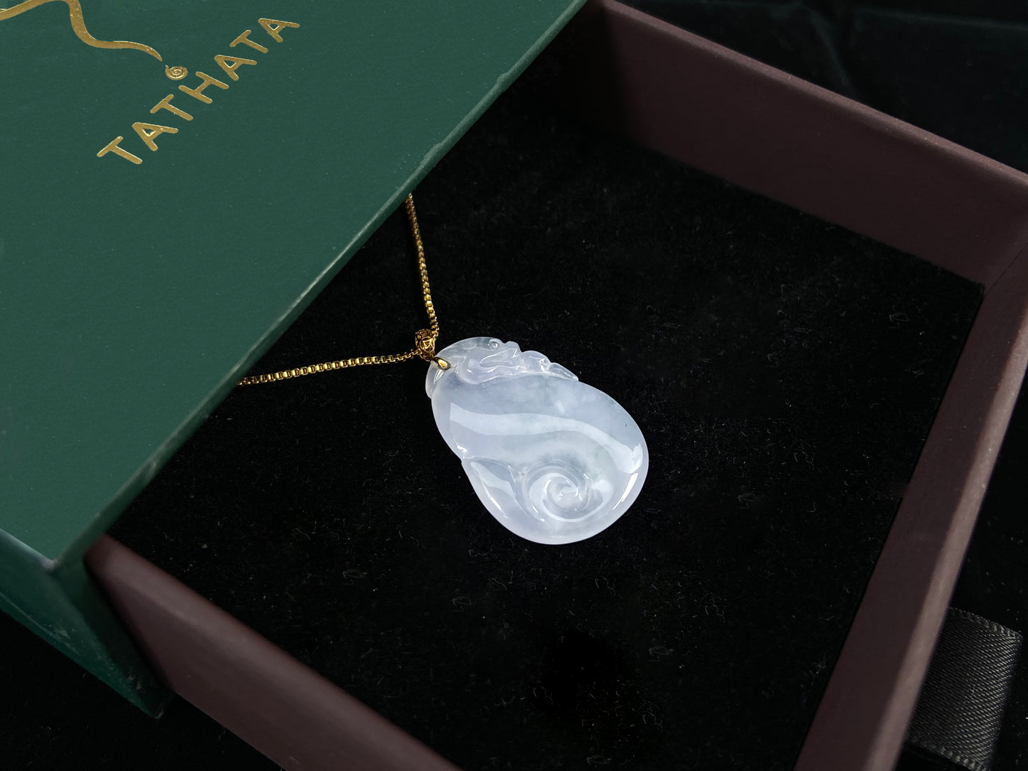 An icy jadeite carving of a Pixiu with a Ruyi body.