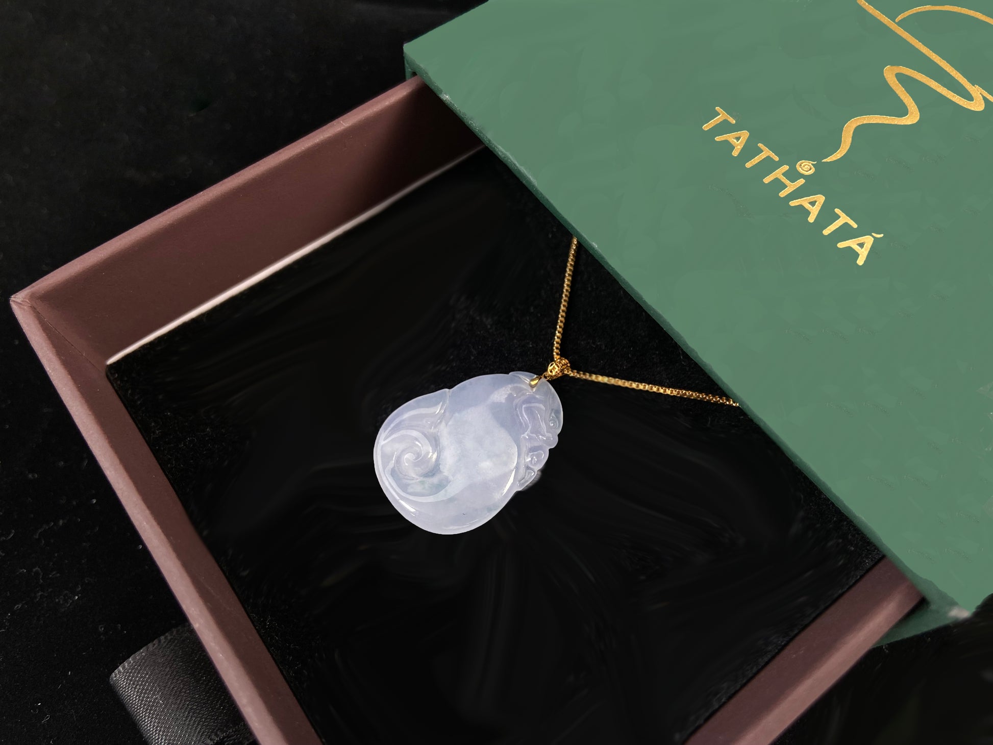 An icy jadeite carving of a Pixiu with a Ruyi body.