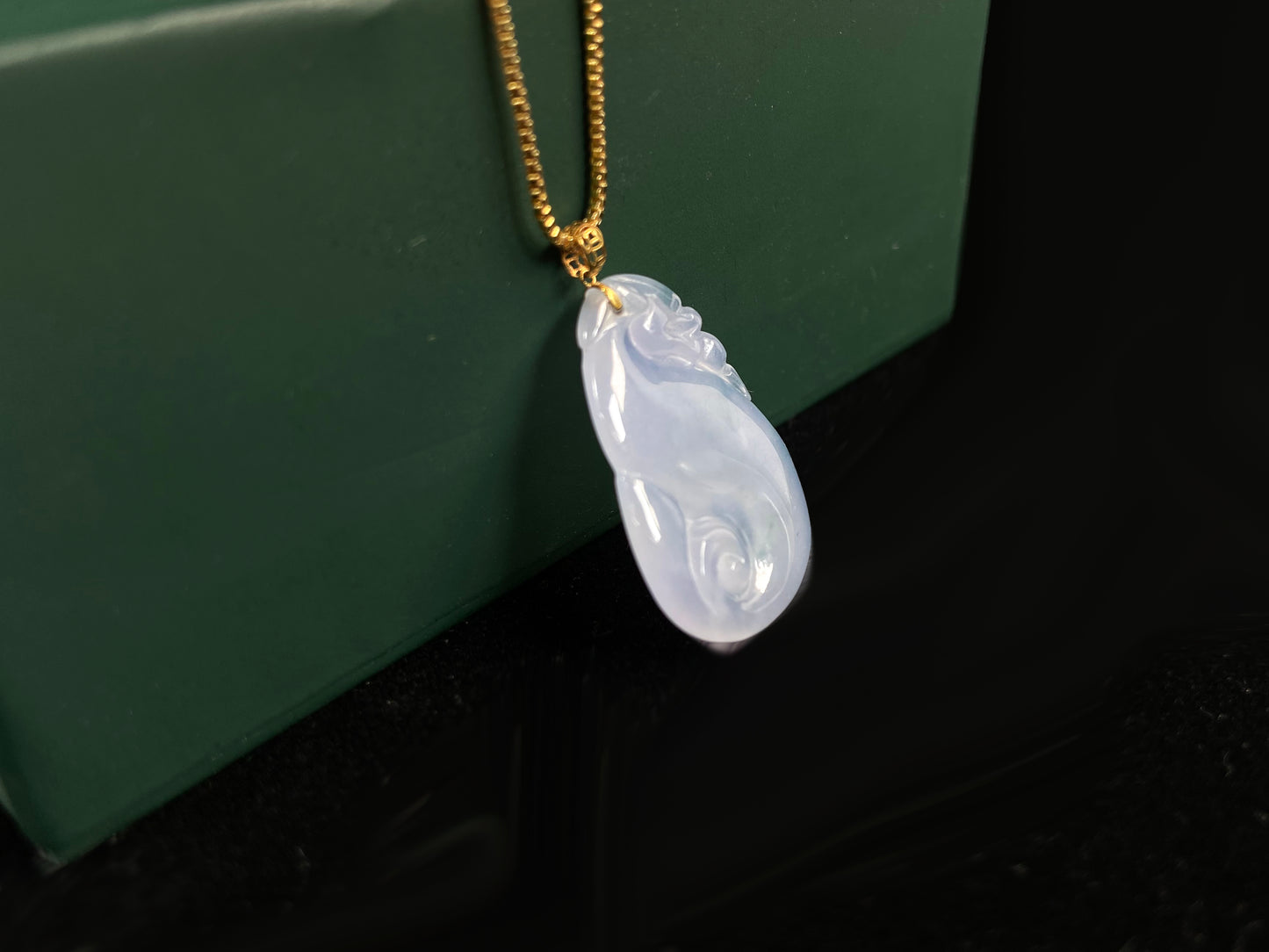 An icy jadeite carving of a Pixiu with a Ruyi body.