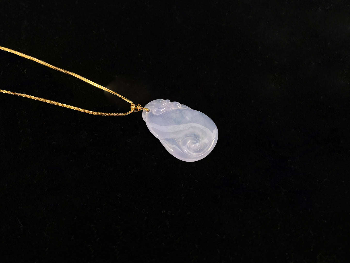 An icy jadeite carving of a Pixiu with a Ruyi body.