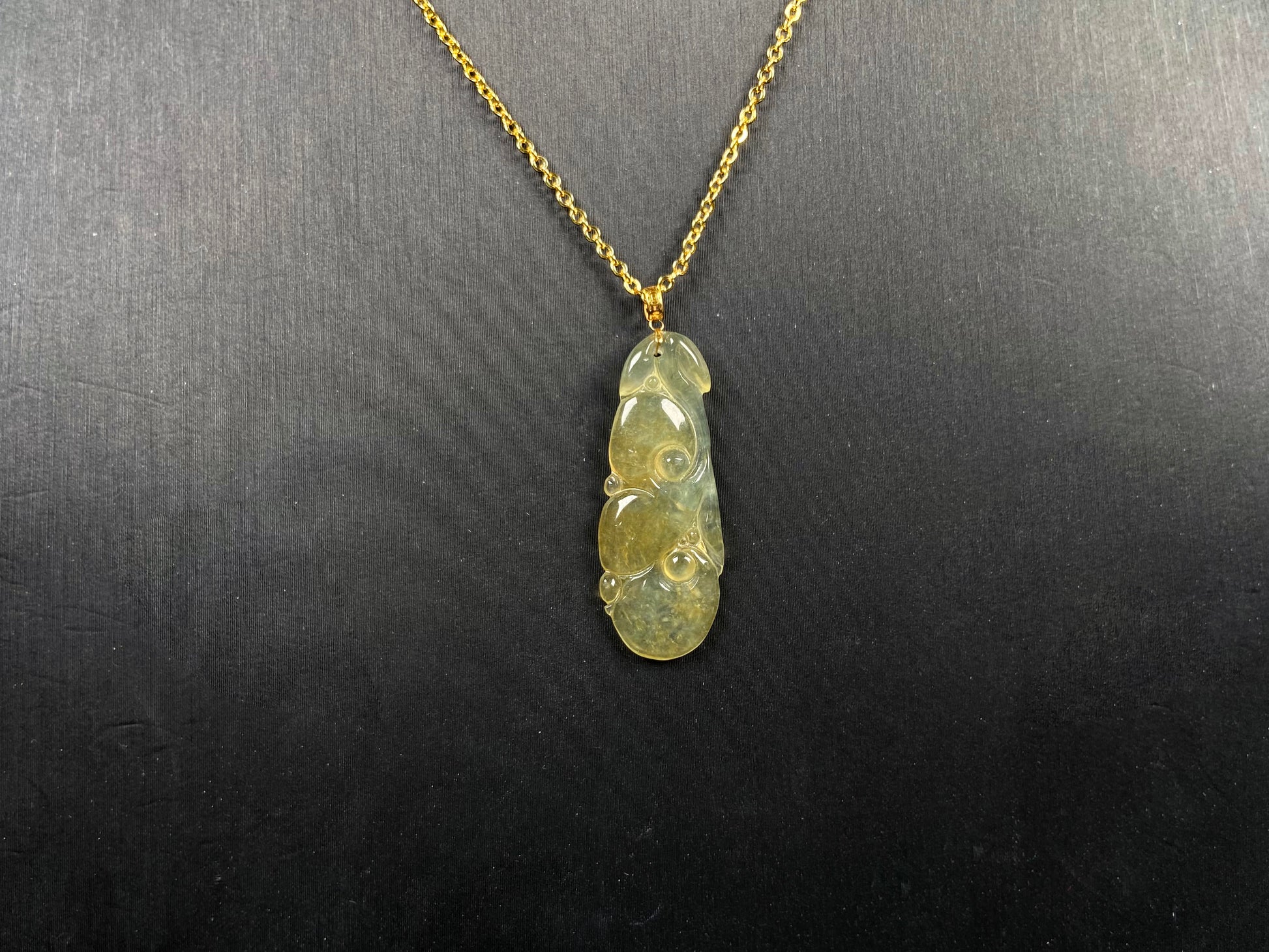 A honey yellow ruyi jadeite pendant.