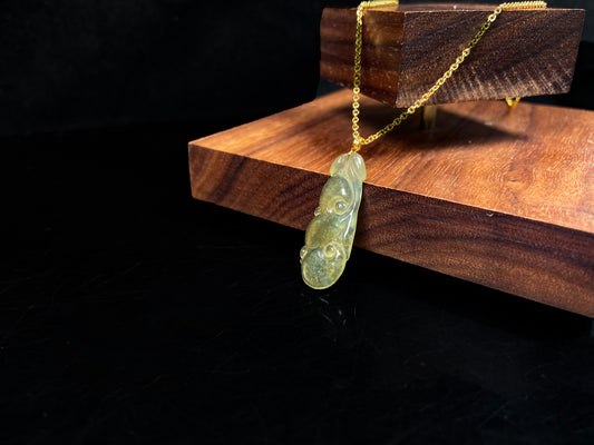 A honey yellow ruyi jadeite pendant.