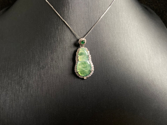 This pendant features a translucent Hulu (gourd) with subtle green veining, elegantly set in 925 silver.
