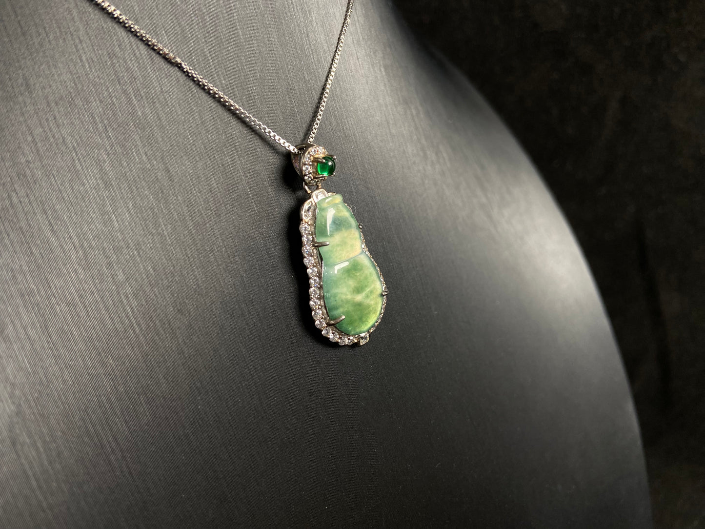 This pendant features a translucent Hulu (gourd) with subtle green veining, elegantly set in 925 silver.