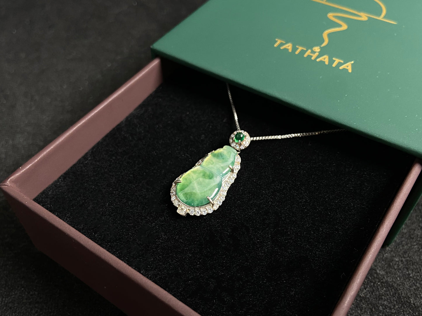 This pendant features a translucent Hulu (gourd) with subtle green veining, elegantly set in 925 silver.