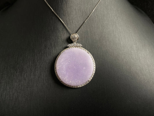 A circular purple jade pendant, elegantly framed in a 925 silver border.