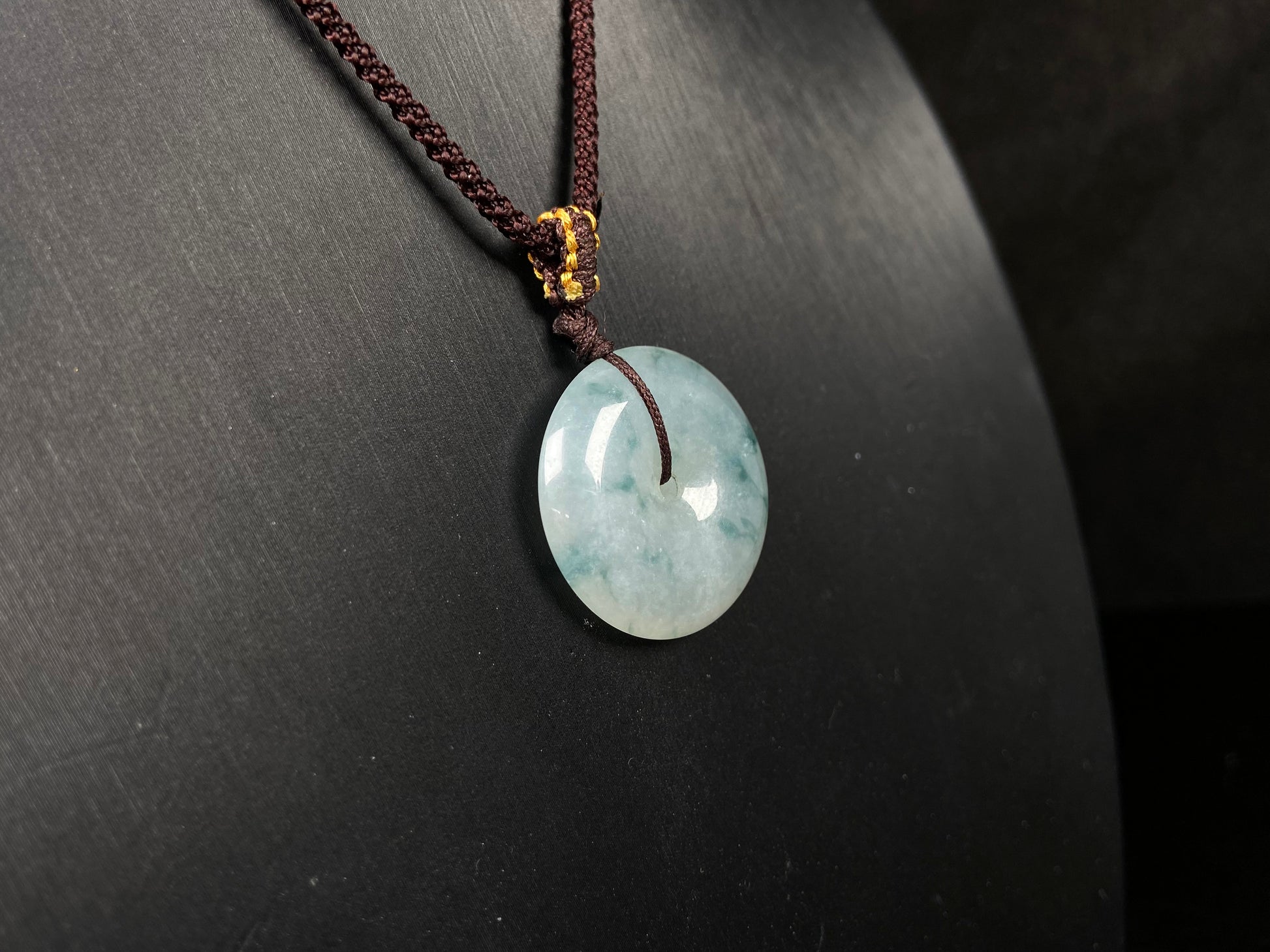 A blue green Ping An Kou jadeite pendant.