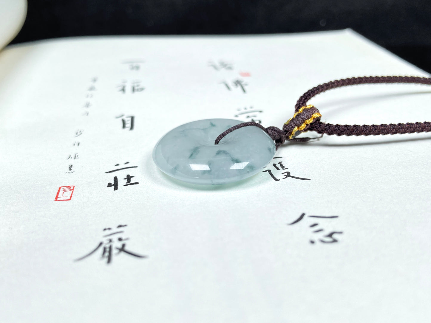 A blue green Ping An Kou jadeite pendant.