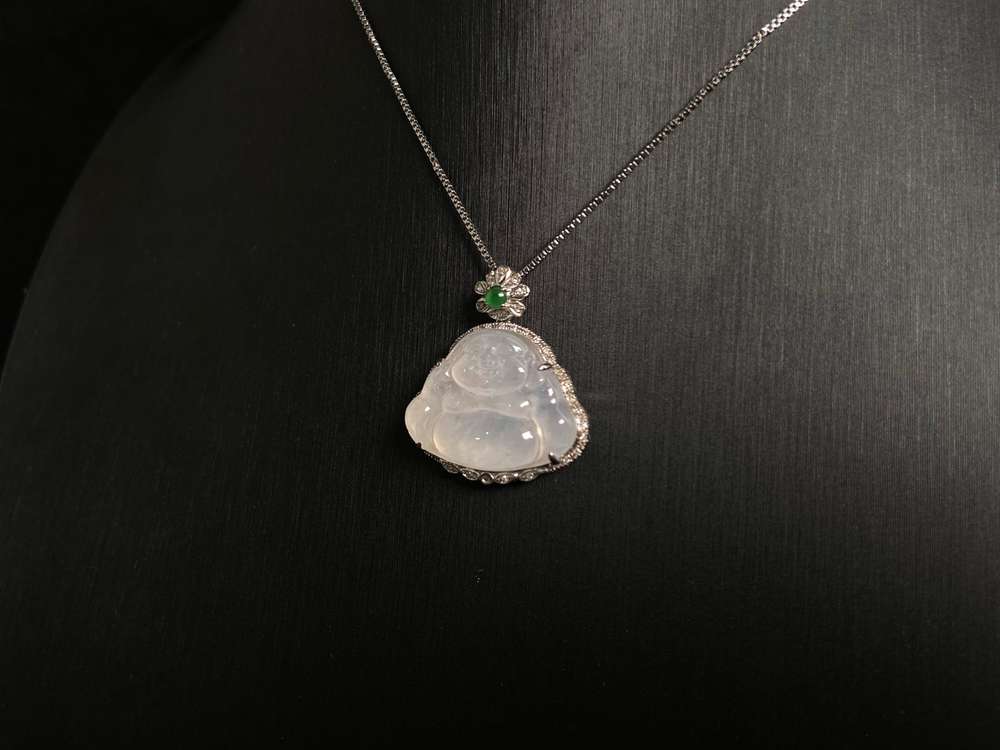 This pendant features a translucent white Maitreya Buddha, symbolizing auspiciousness and protection, set in 18 gold to inspire wisdom and serenity.
