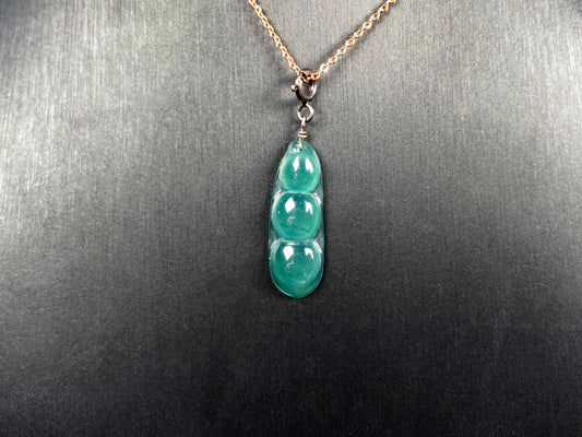 A watery blue lucky pea pod jadeite pendant.