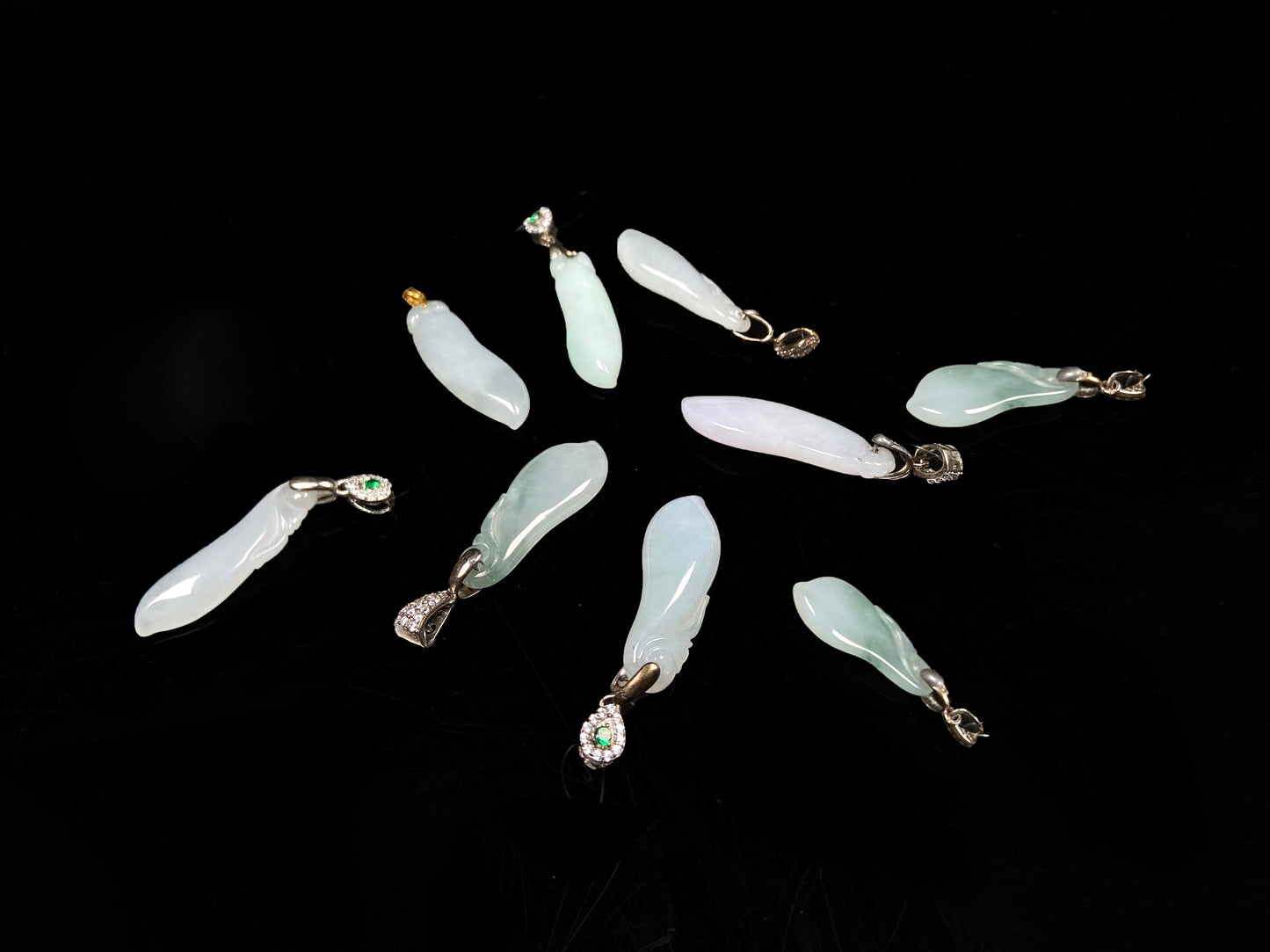 A group of white green smooth fortune melon naJadeite pendant.