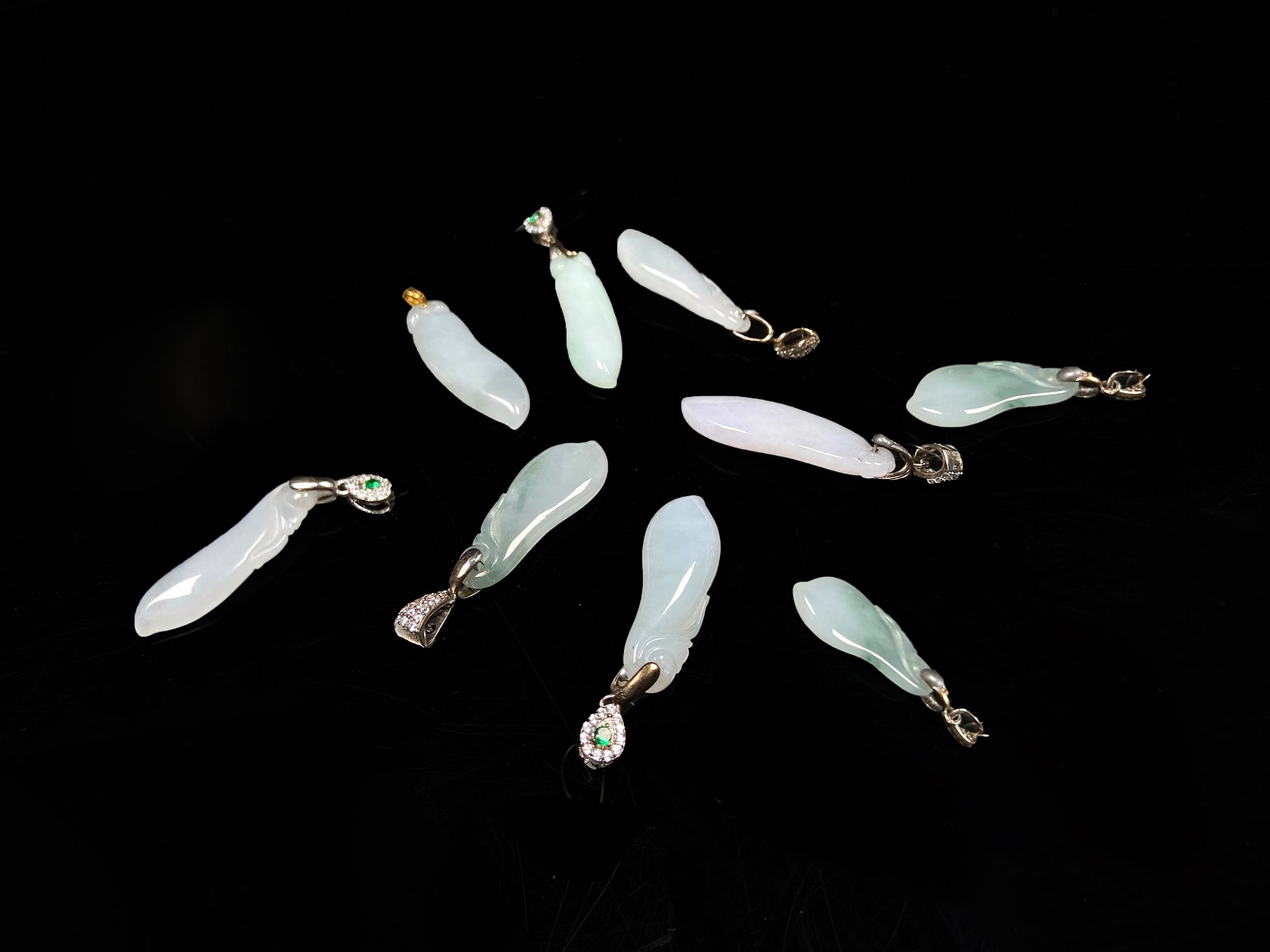 A group of white green smooth fortune melon naJadeite pendant.