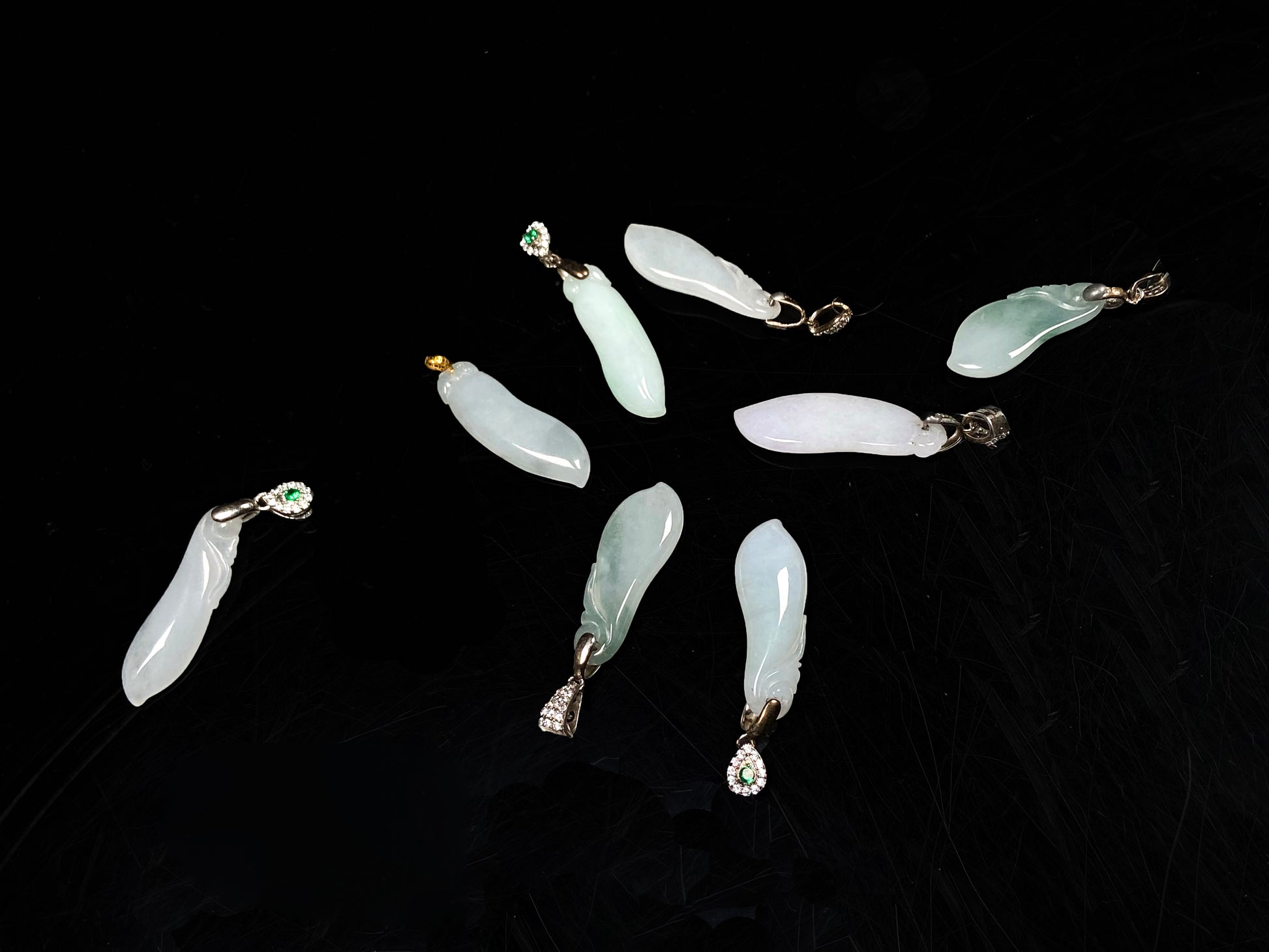 A group of white green smooth fortune melon naJadeite pendant.