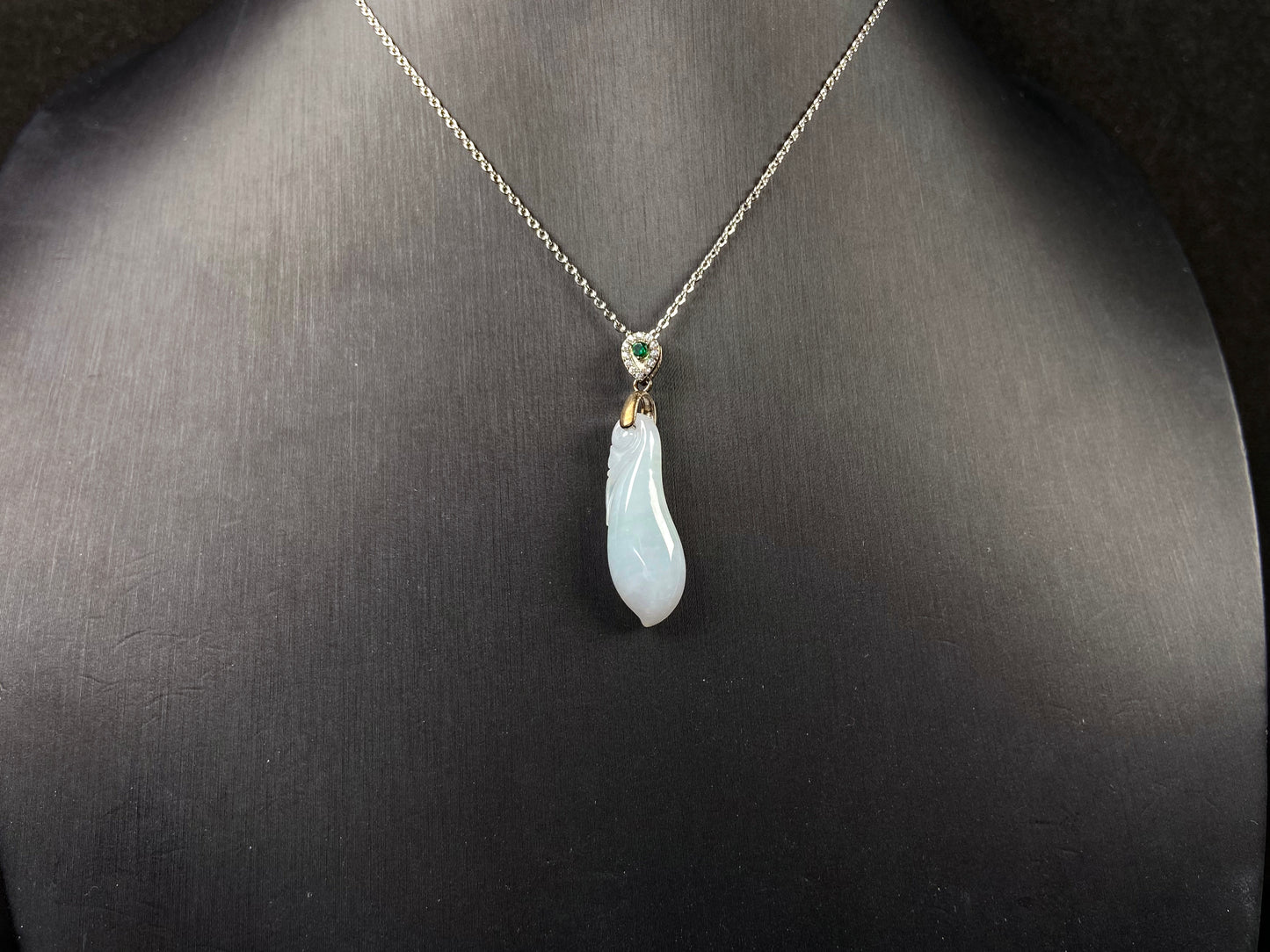 A white green smooth fortune melon naJadeite pendant.