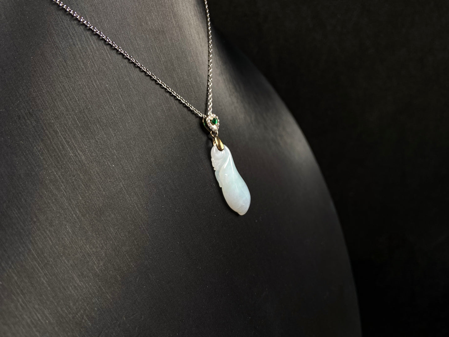 A white green smooth fortune melon naJadeite pendant.