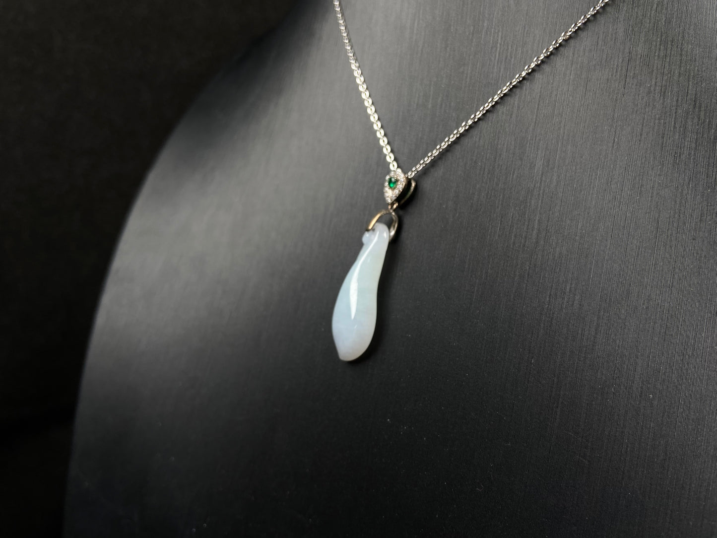 A white green smooth fortune melon naJadeite pendant.