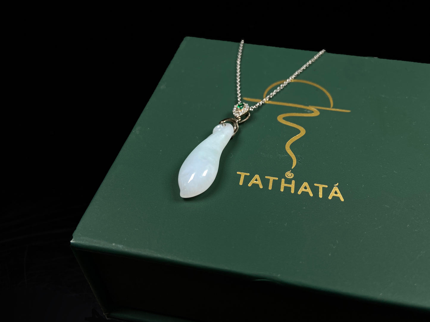 A white green smooth fortune melon naJadeite pendant.