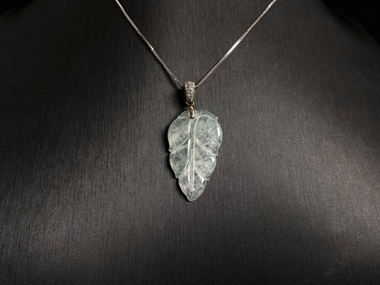An icy jade leaf pendant, elegant and pure.