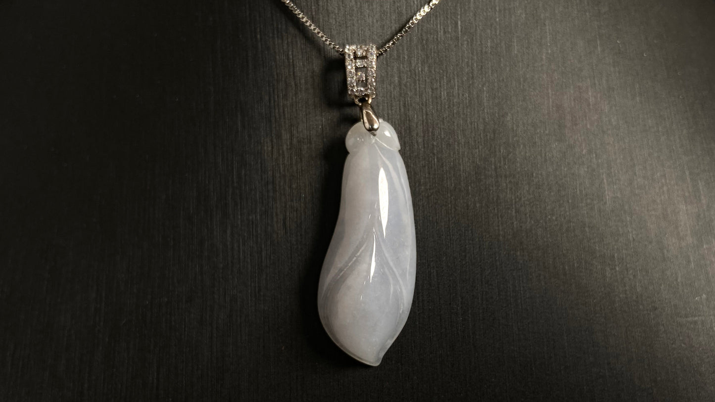 A milky white jade orchid blossom pendant, elegant and pure in its simplicity.