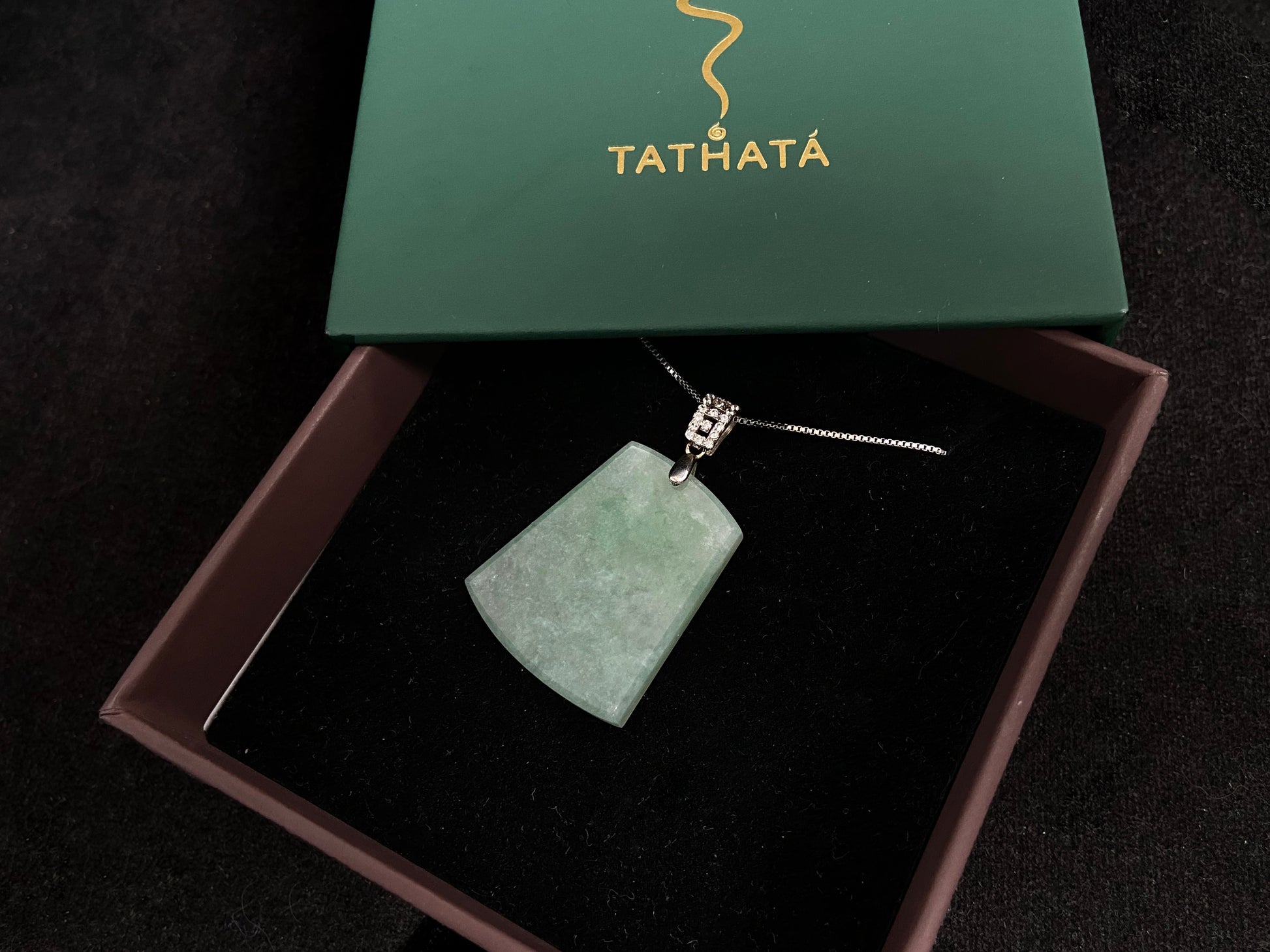 A pale greenish white jade plaque, perfectly plain and polished smooth.