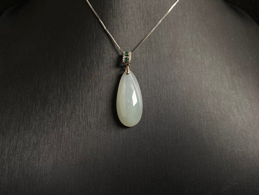 A translucent, milky white jade pendant crafted in a graceful teardrop shape.