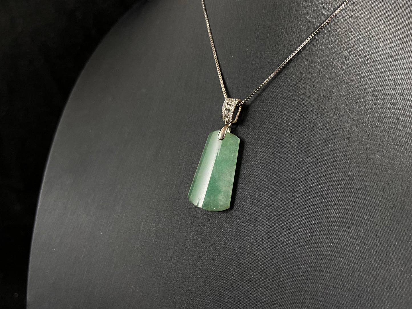 This jade pendant is a peace plaque with a green base.