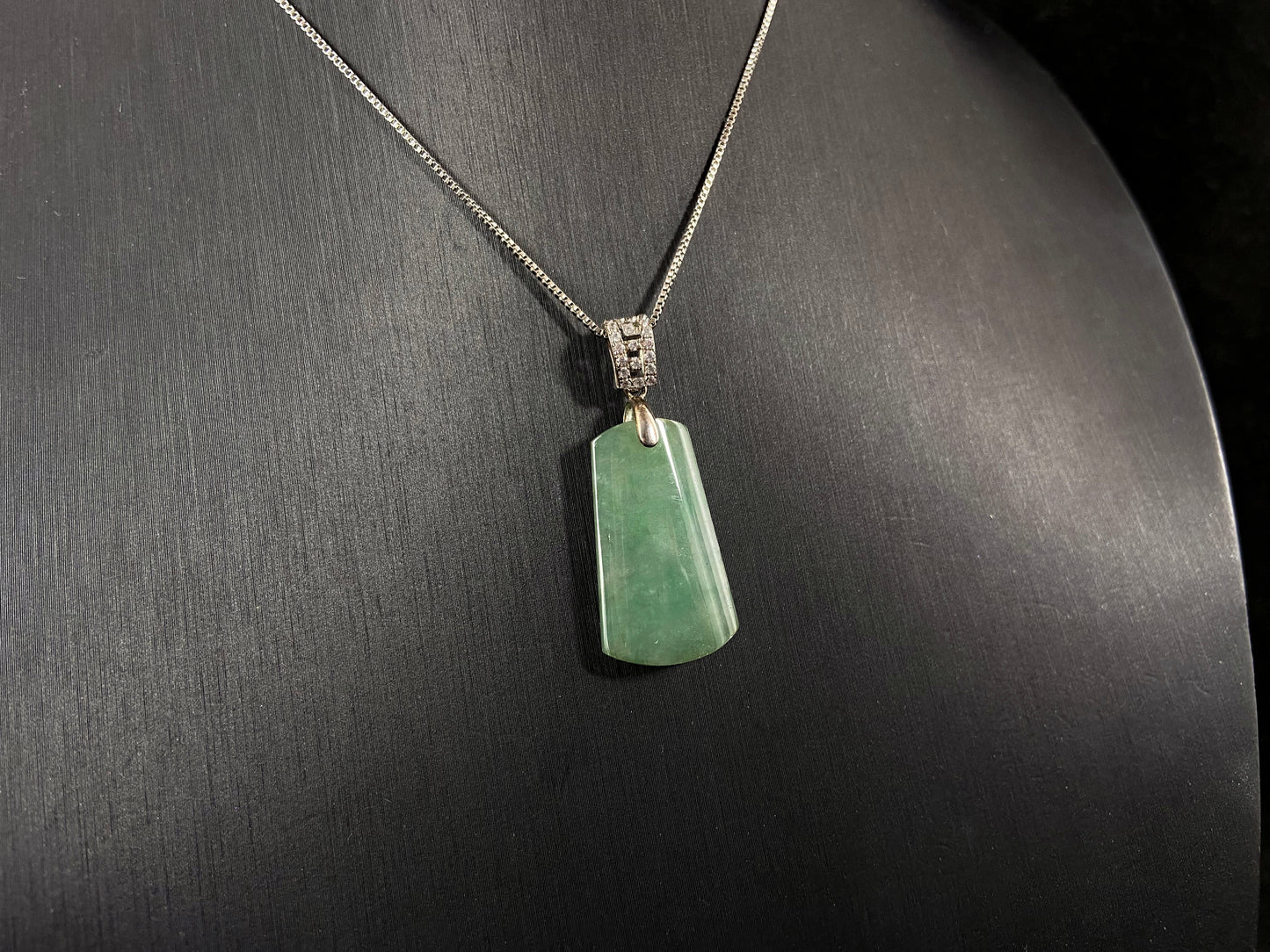 This jade pendant is a peace plaque with a green base.