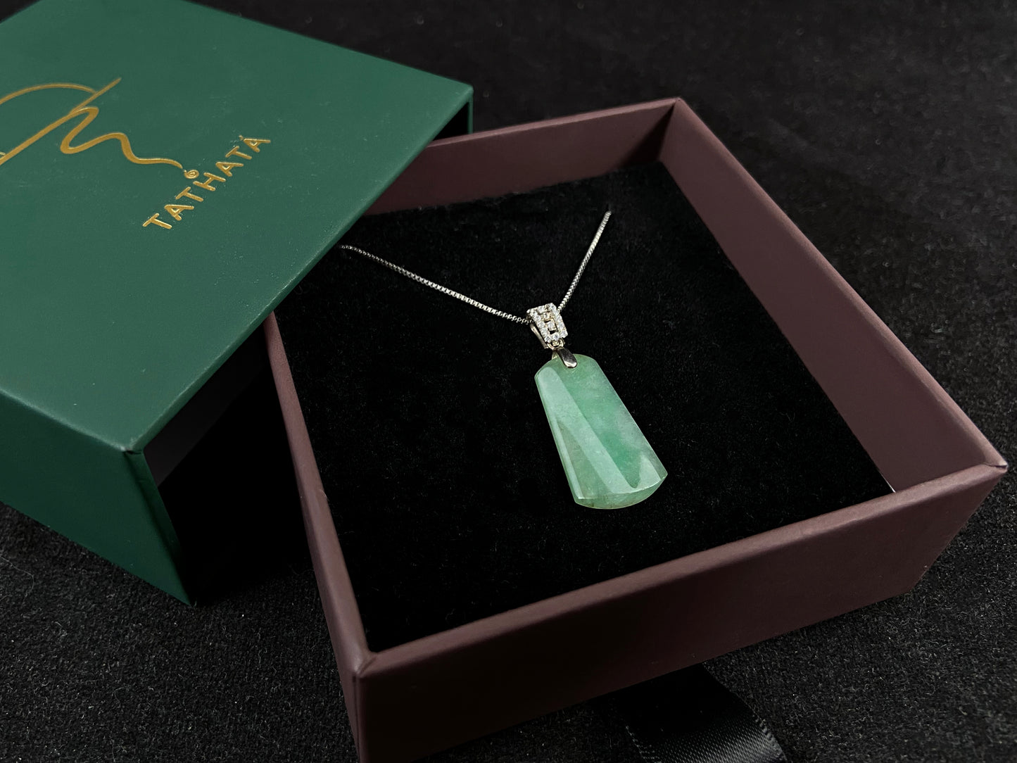 This jade pendant is a peace plaque with a green base.