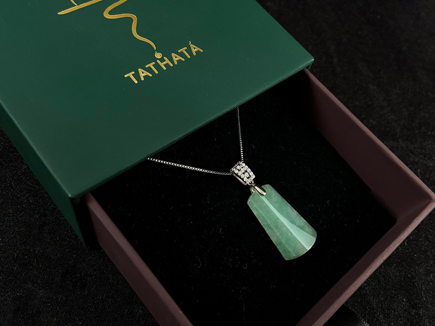 This jade pendant is a peace plaque with a green base.