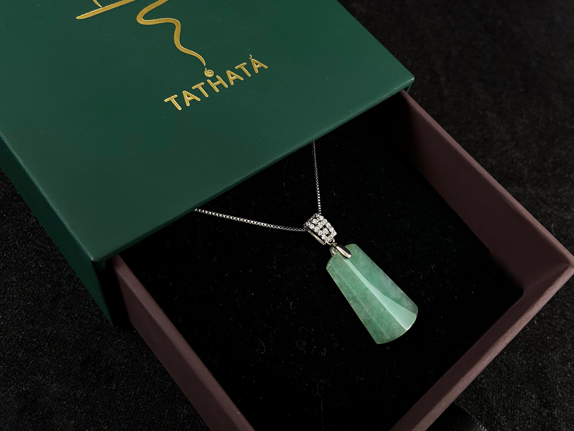 This jade pendant is a peace plaque with a green base.