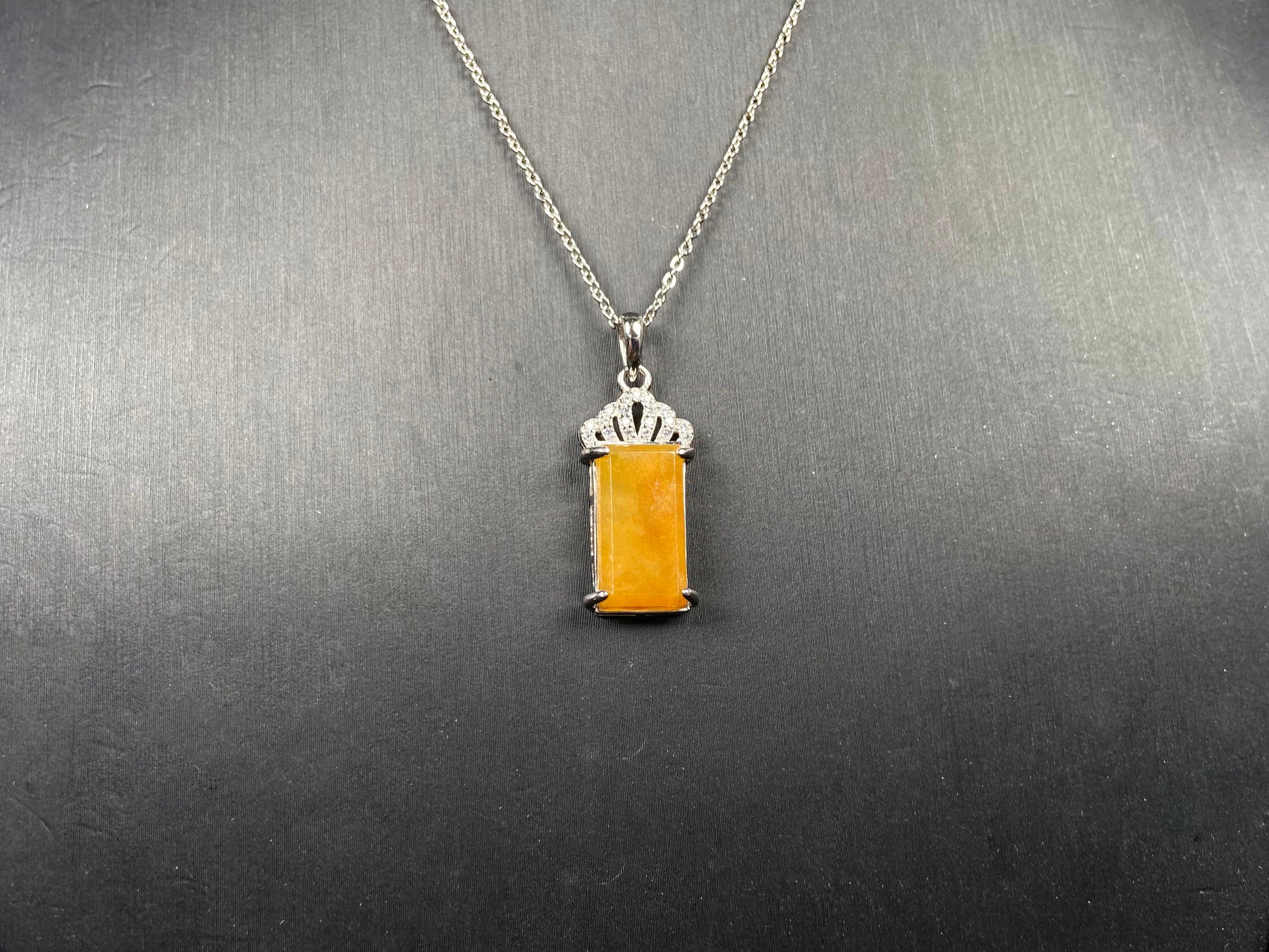 A amber glow of royal crown jadeite pendant.