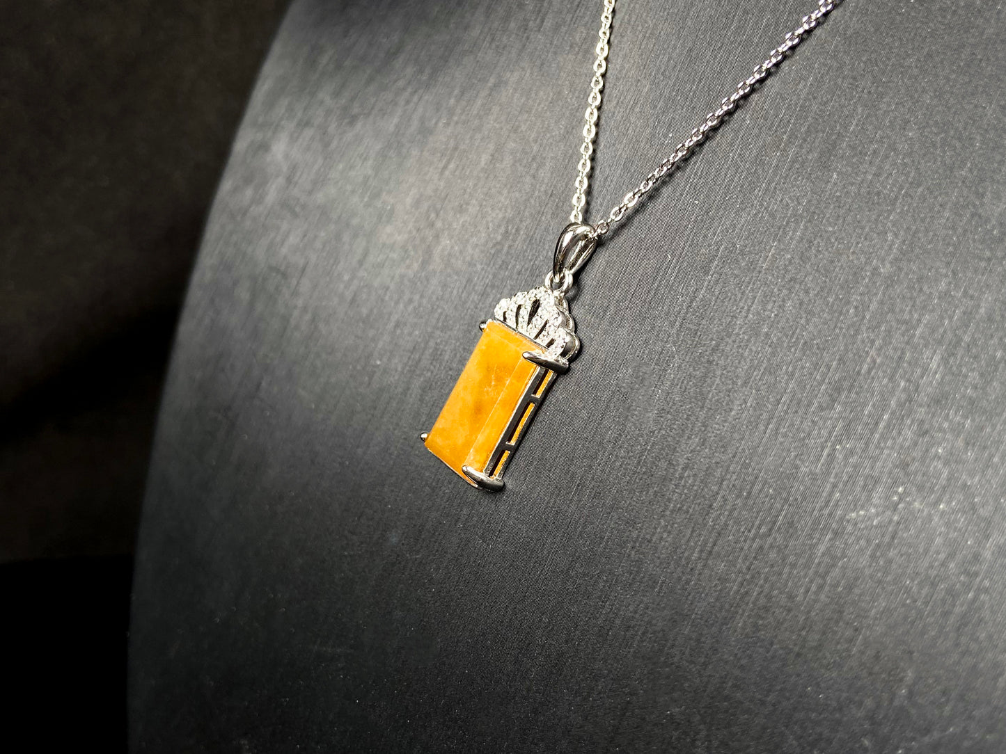 A amber glow of royal crown jadeite pendant.