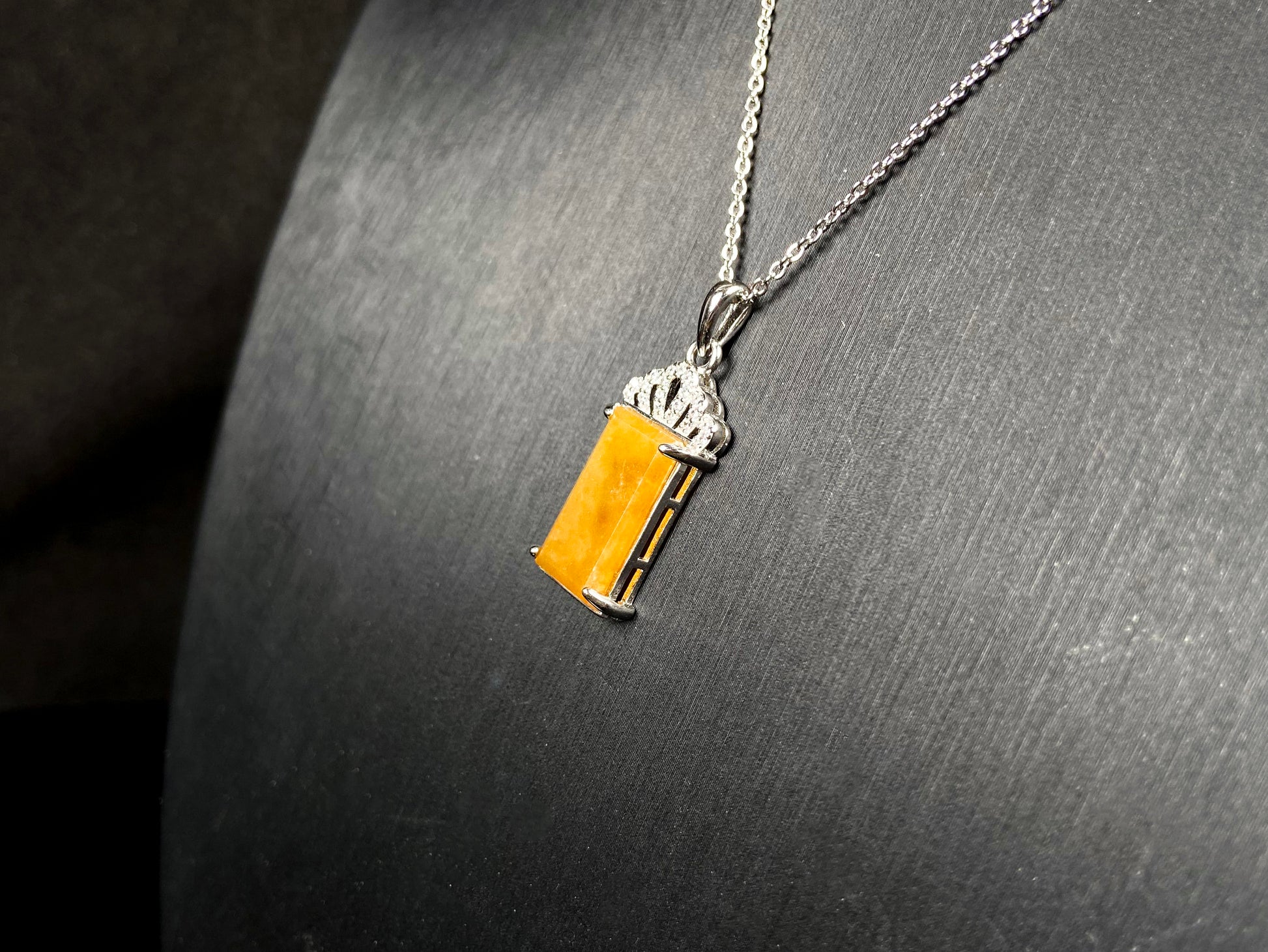 A amber glow of royal crown jadeite pendant.
