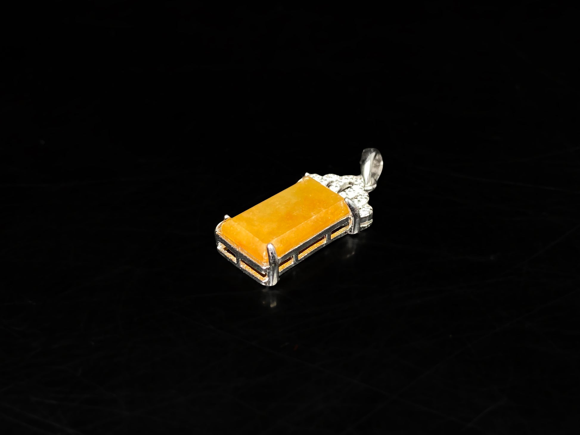 A amber glow of royal crown jadeite pendant.