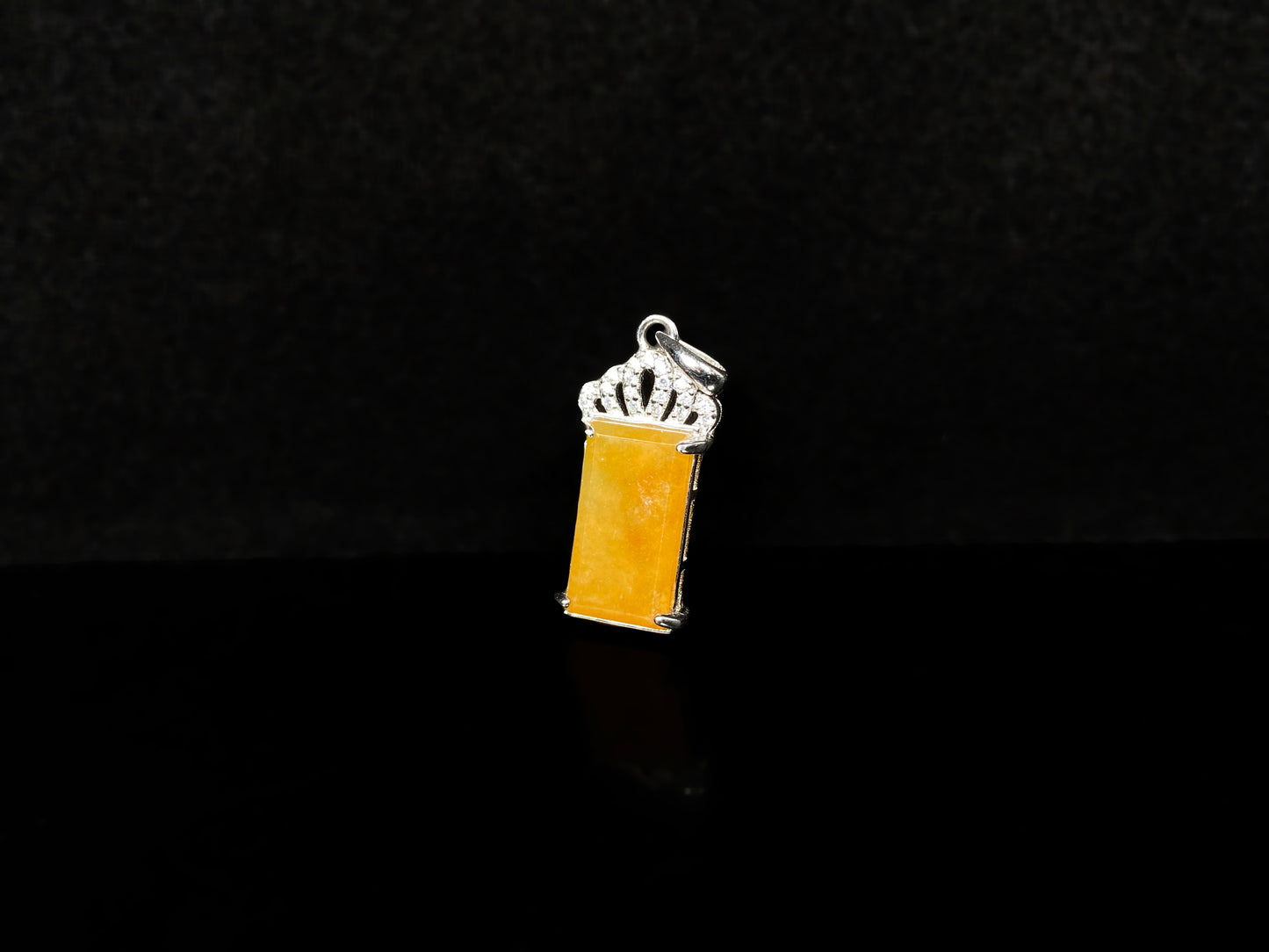 A amber glow of royal crown jadeite pendant.