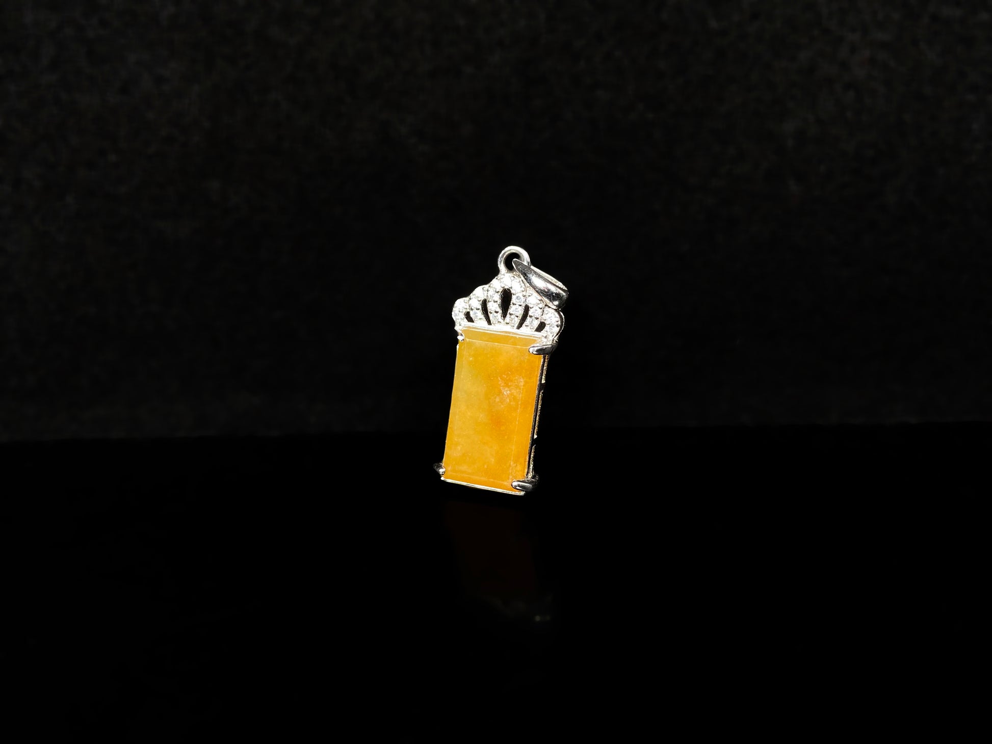 A amber glow of royal crown jadeite pendant.