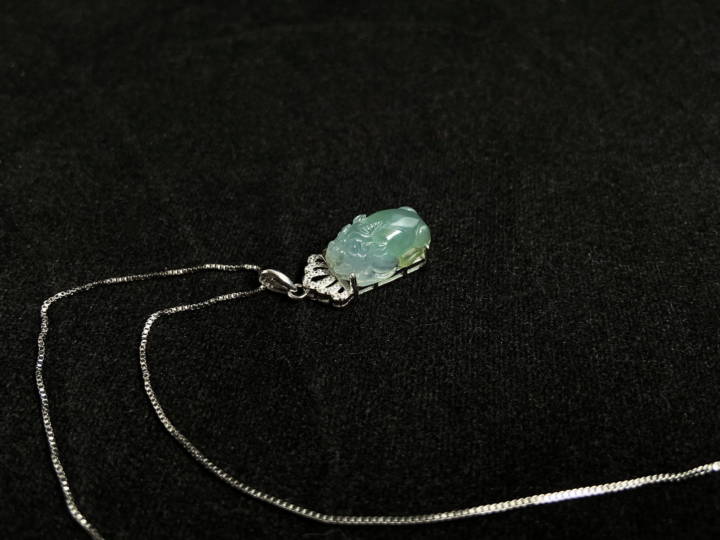 A light green jade Pixiu crowned with a diamond studded 925 silver tiara.