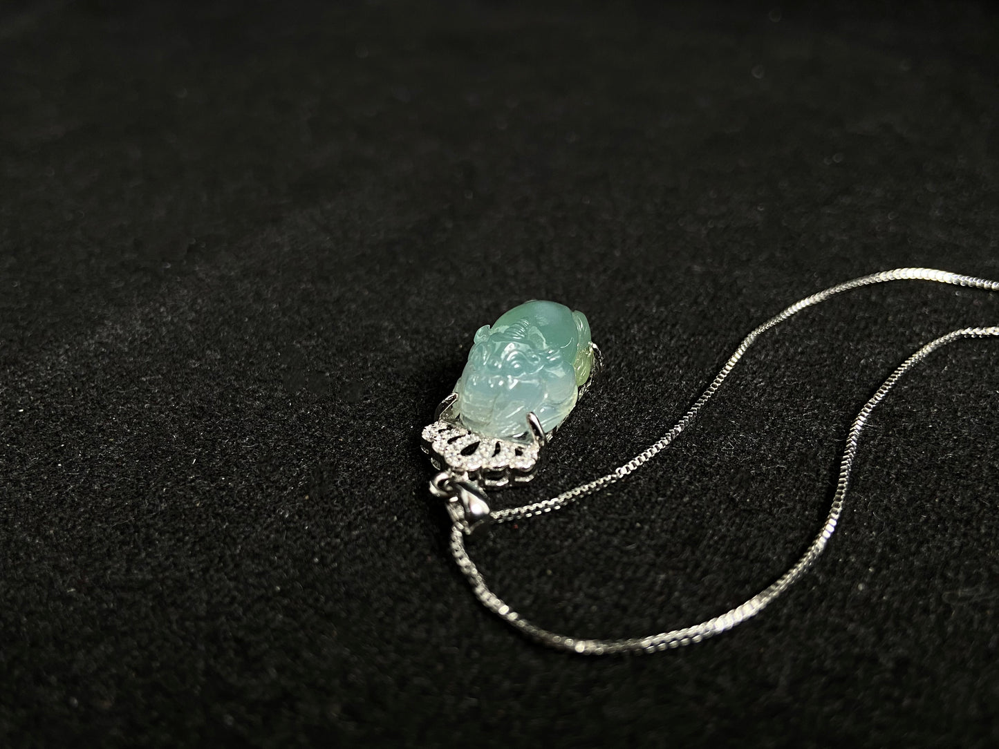 A light green jade Pixiu crowned with a diamond studded 925 silver tiara.