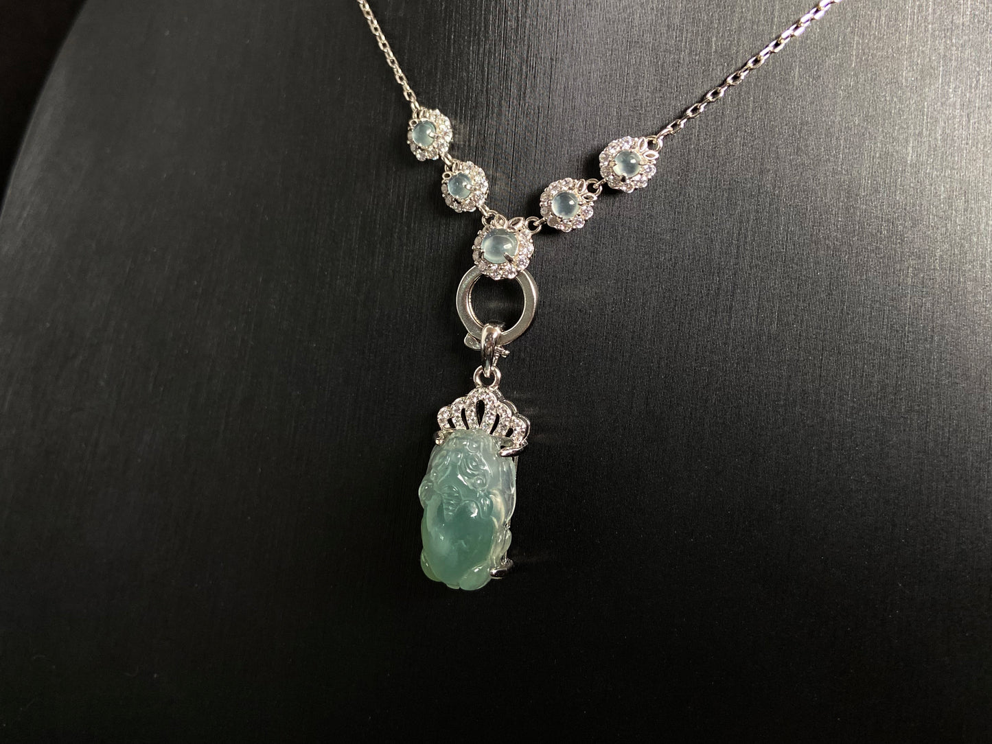 A light green jade Pixiu crowned with a diamond studded 925 silver tiara.